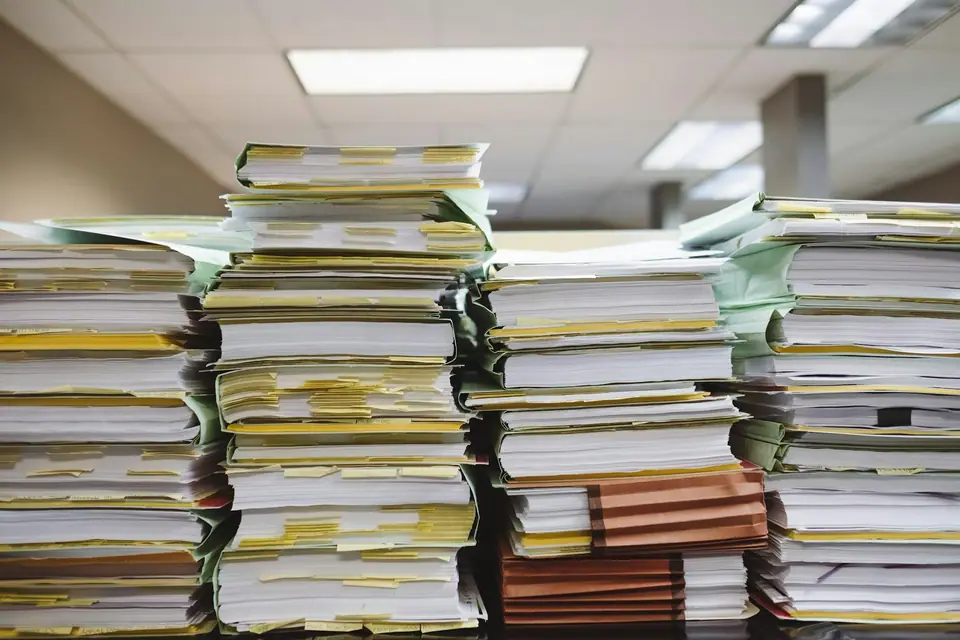 Stacks of paper files and folders