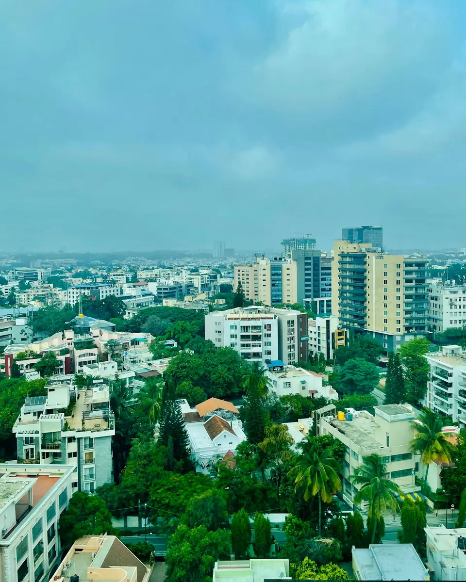 Bengaluru skyline with towers rising above green tree cover